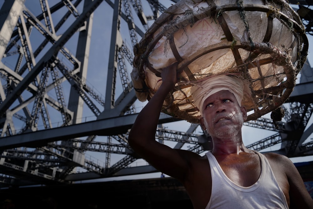 a man holding a large object on his head