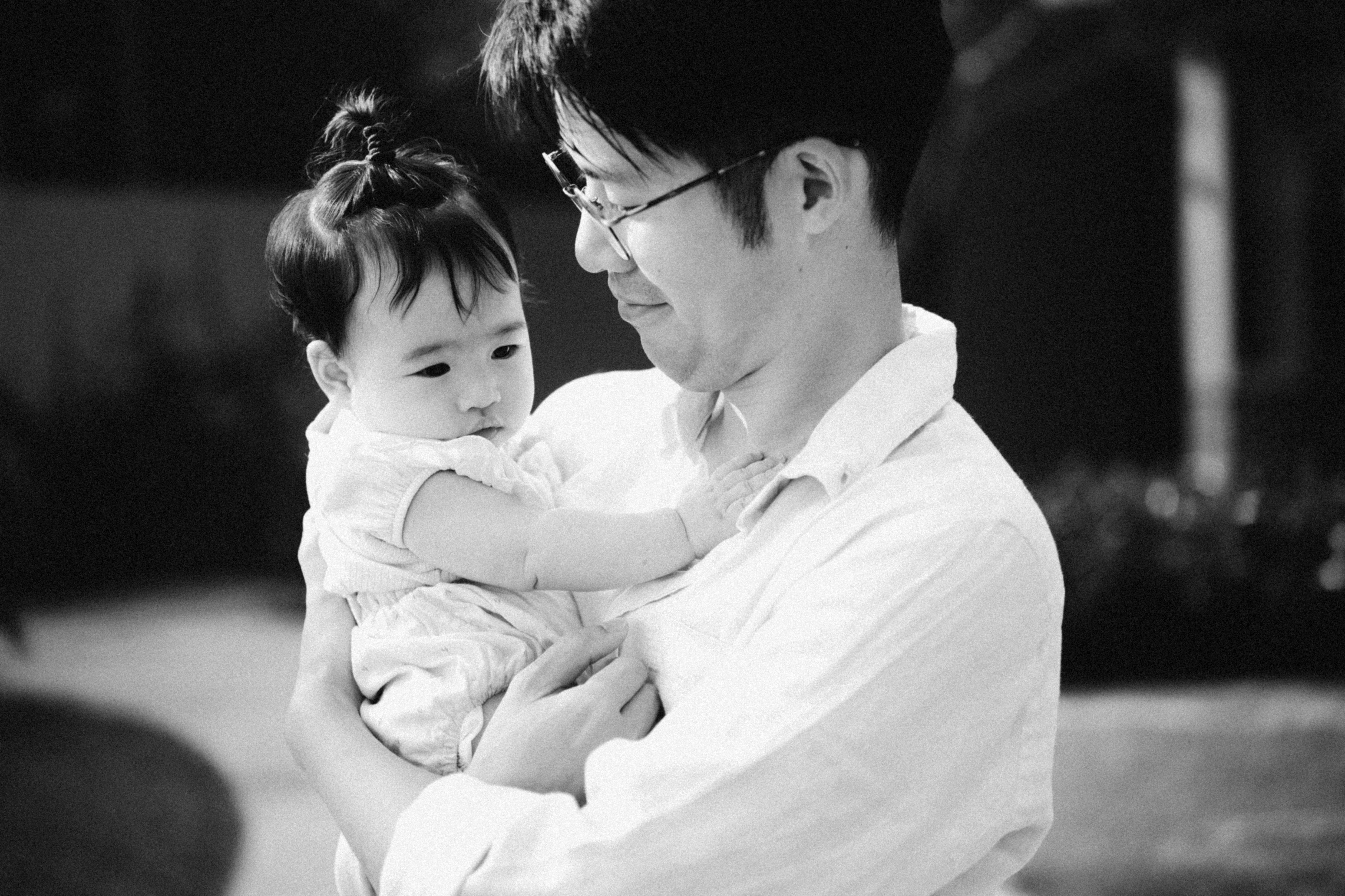 a man holding a baby in his arms