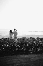 a man and a woman are standing in a field
