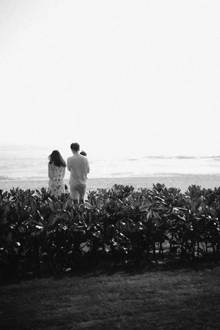 a man and a woman are standing in a field