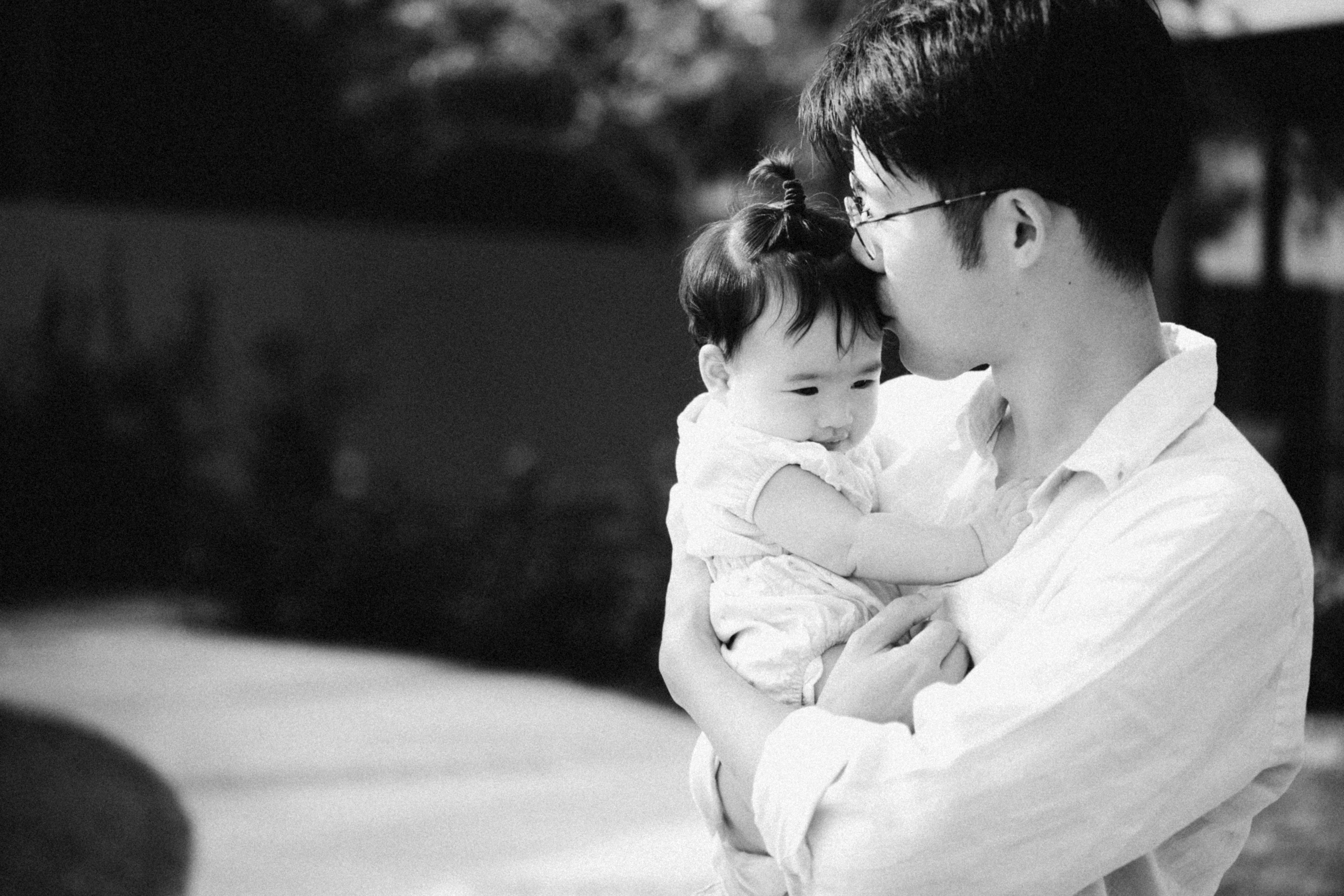 a man holding a baby in his arms