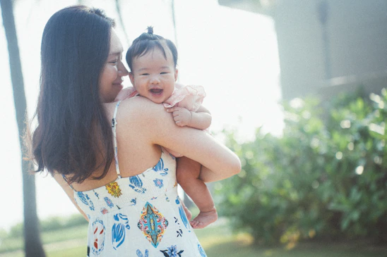 a woman holding a baby in her arms