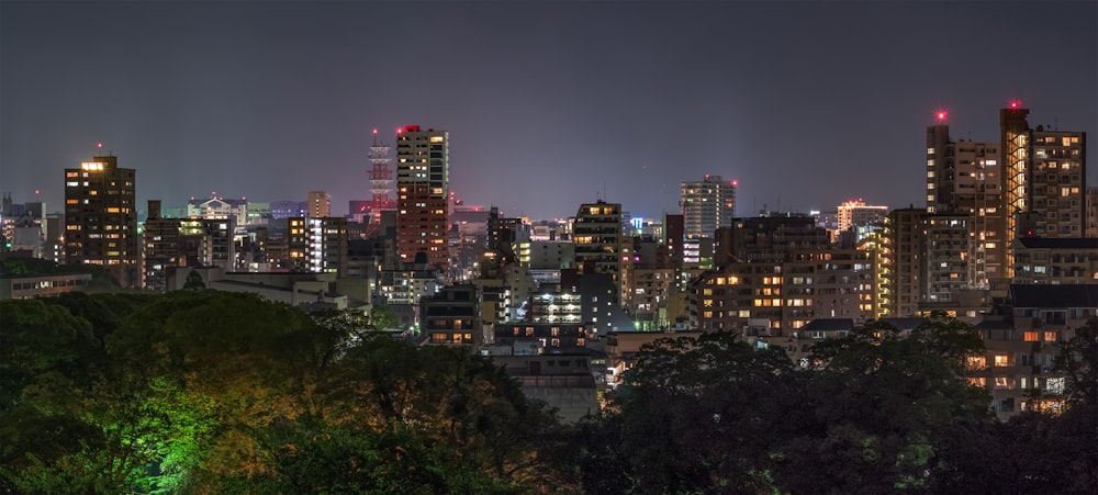 a view of a city at night from a hill