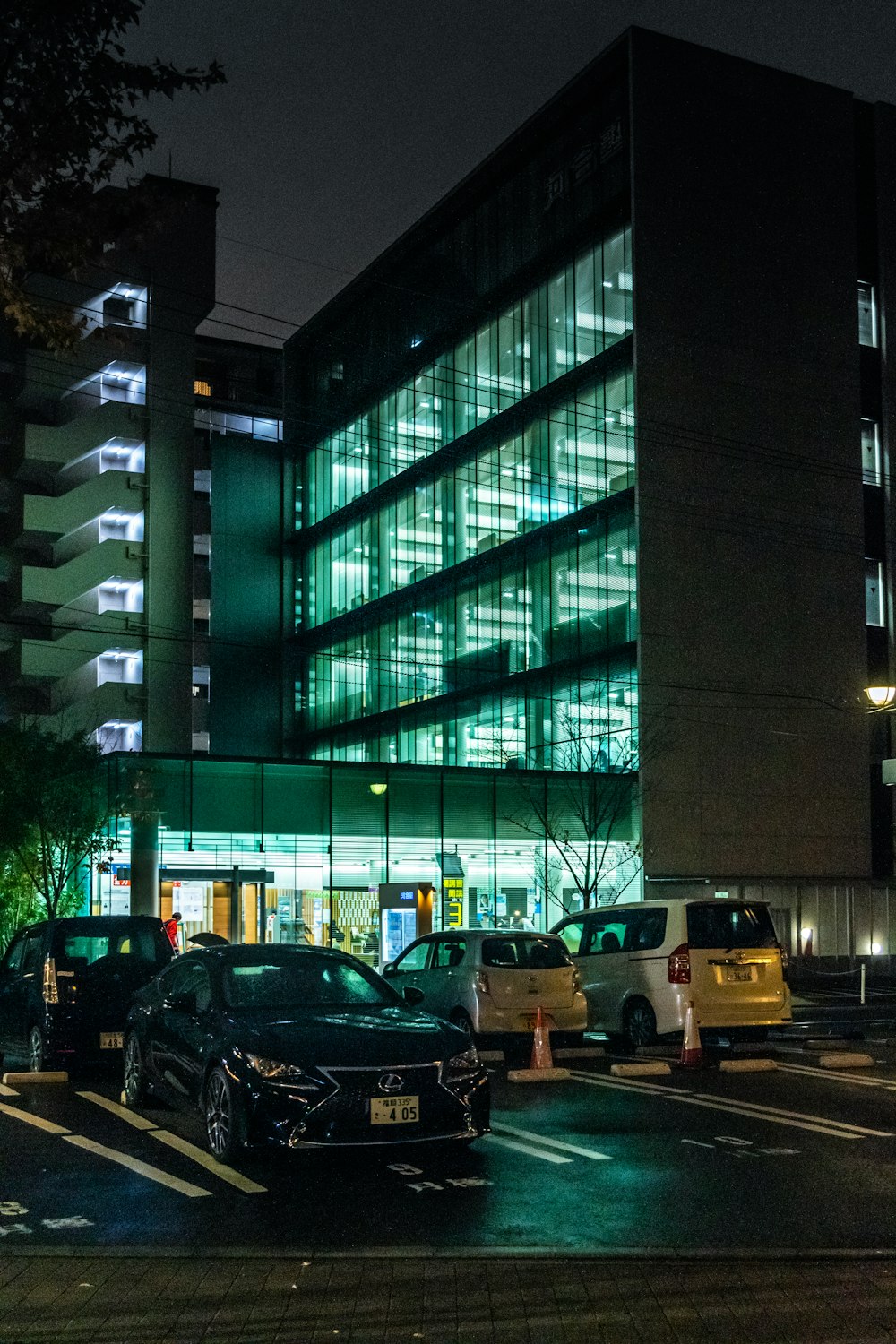 cars parked in front of a building at night