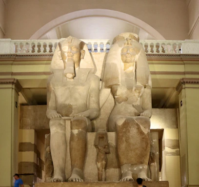 a couple of statues sitting in a room