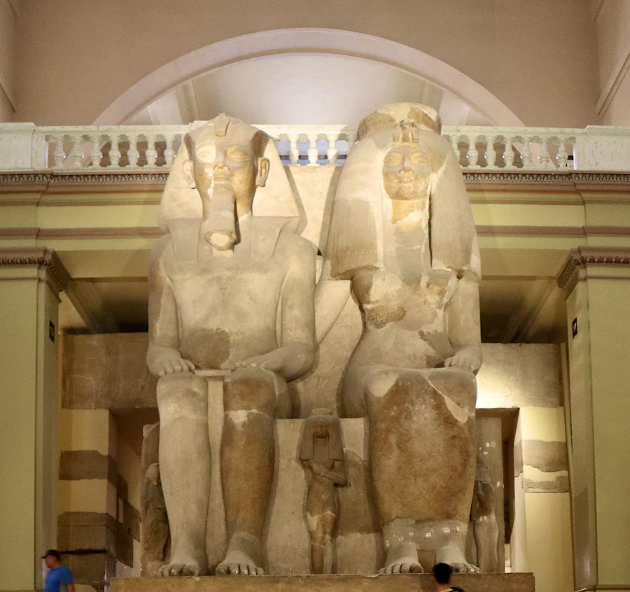 Statues displayed together inside the Grand Egyptian Museum