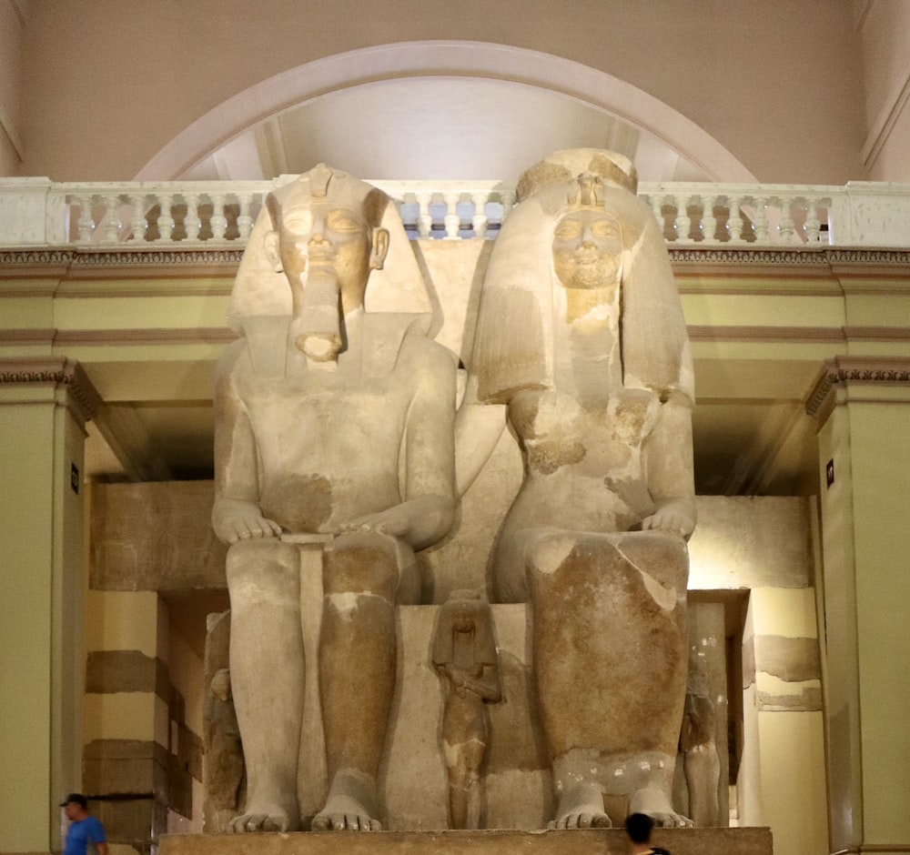 a couple of statues sitting in a room