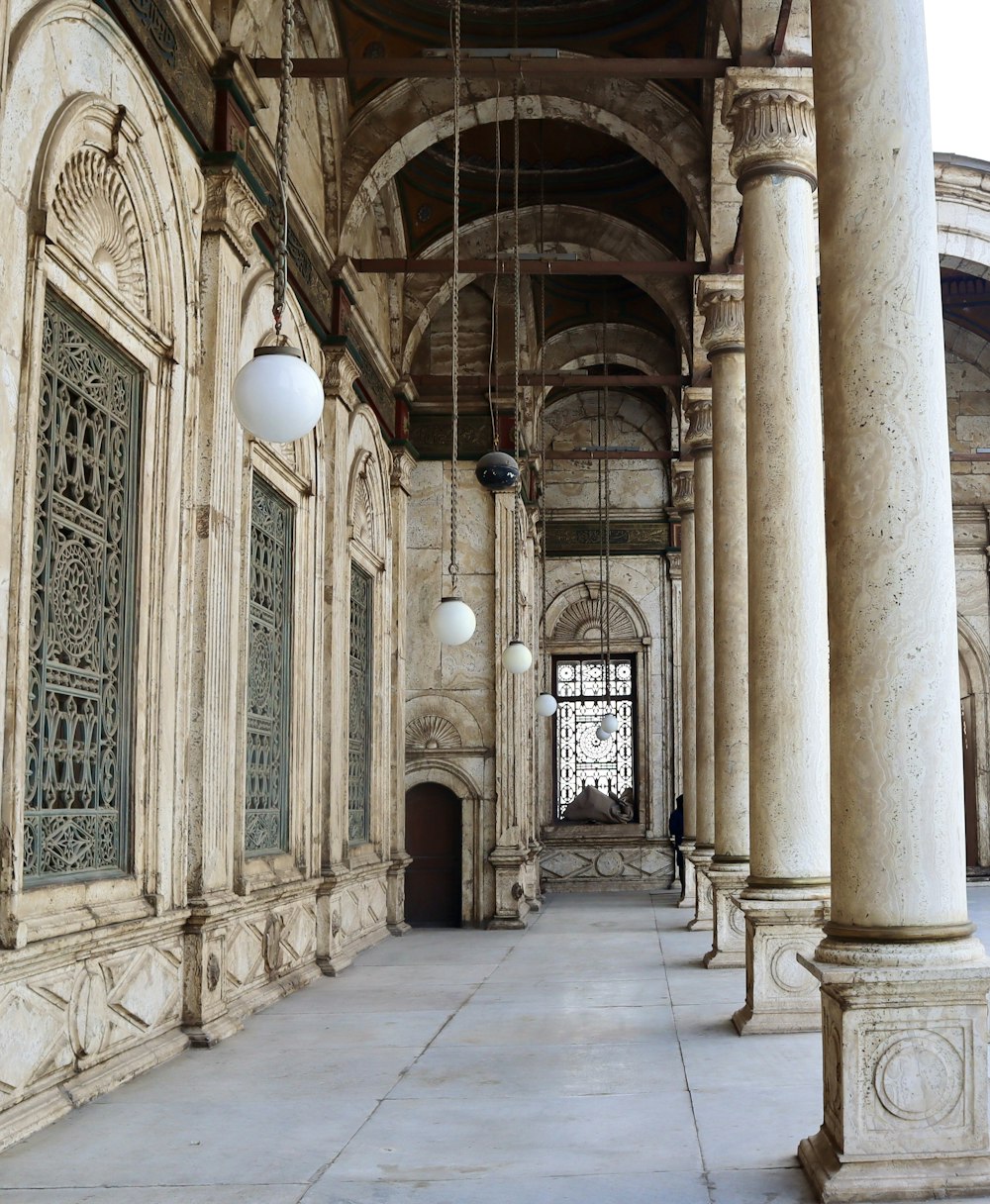 a large building with columns and a clock on the wall