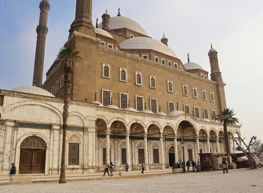 a large building with a lot of people walking around it