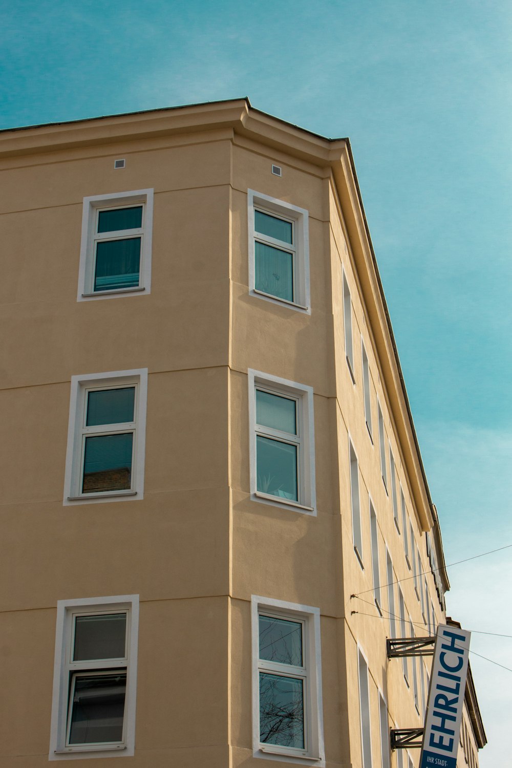 a tall building with a street sign in front of it