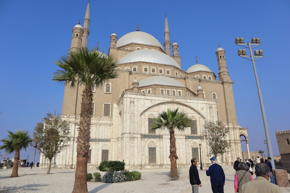 a group of people standing in front of a large building