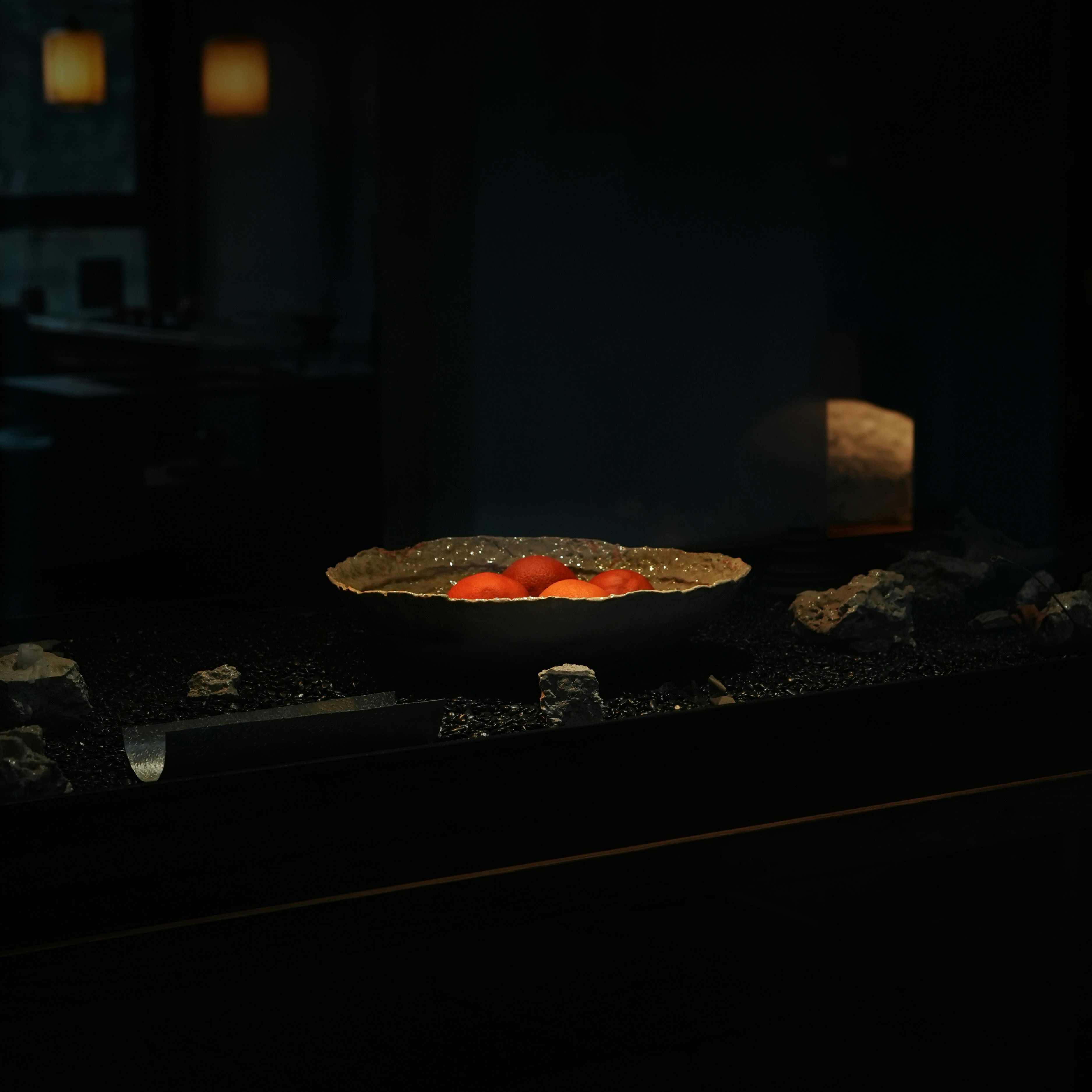 A bowl of tomatoes sitting on top of a counter