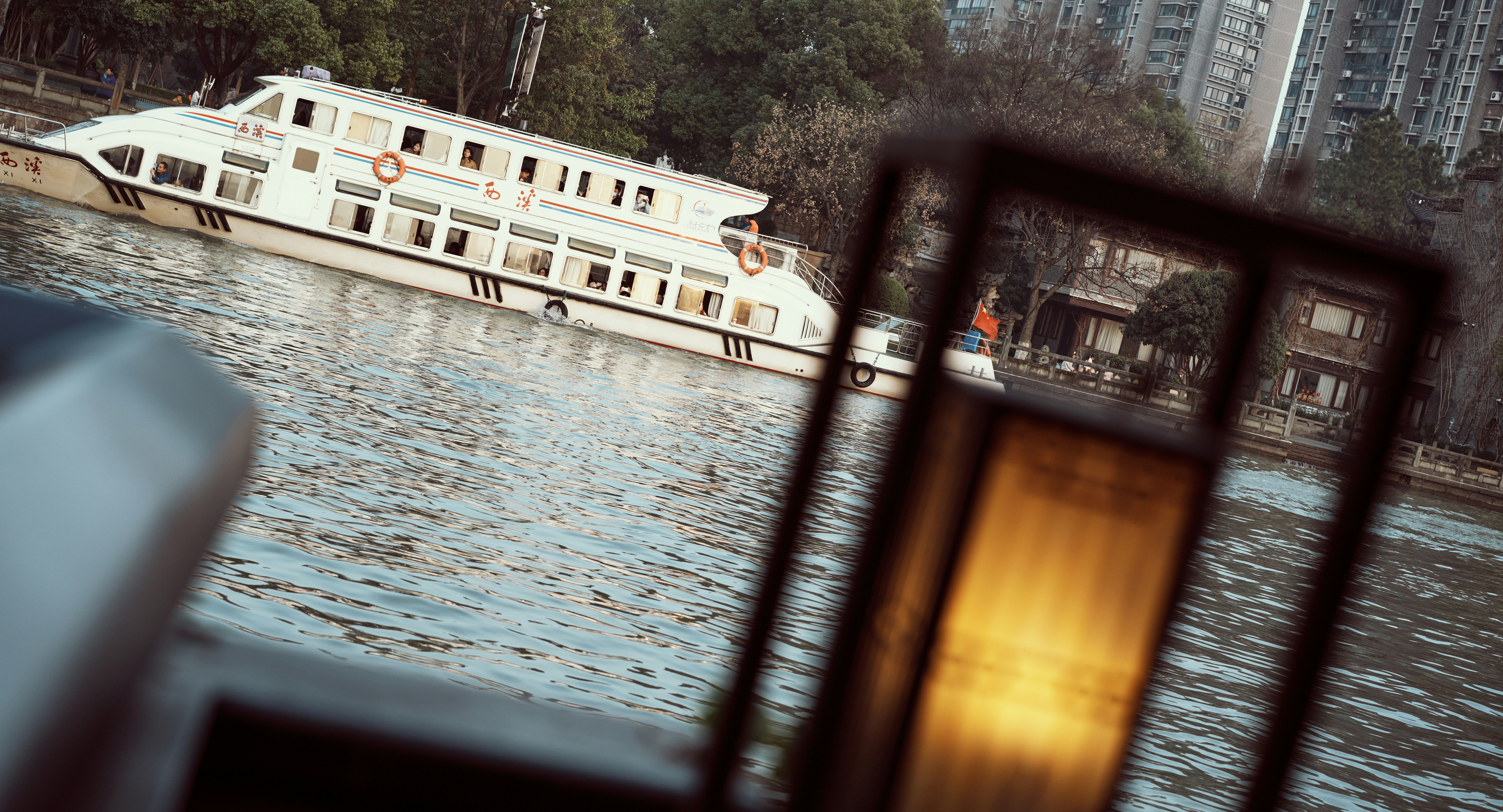 a large white boat floating on top of a river
