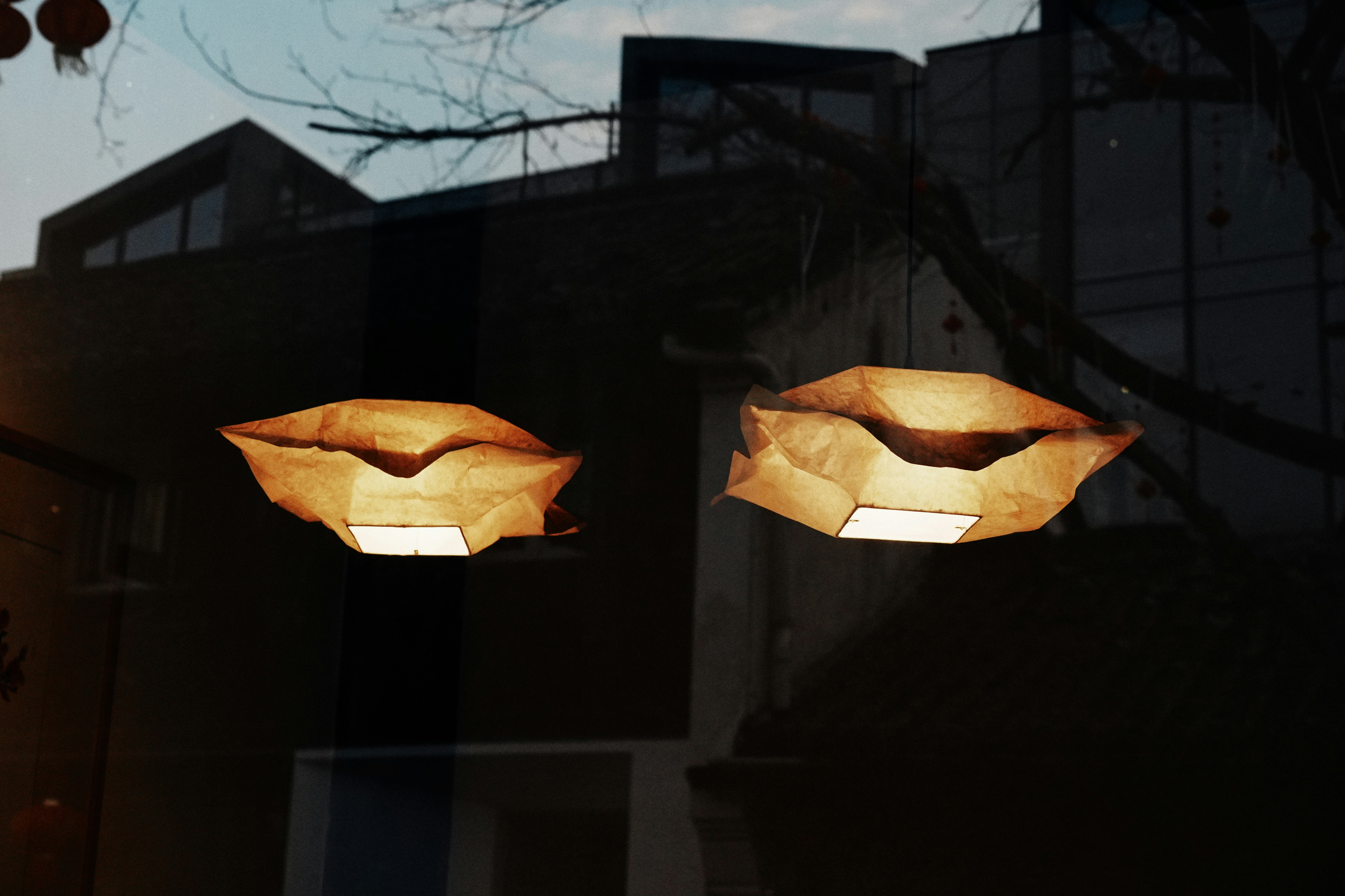 a couple of lights hanging from the side of a building