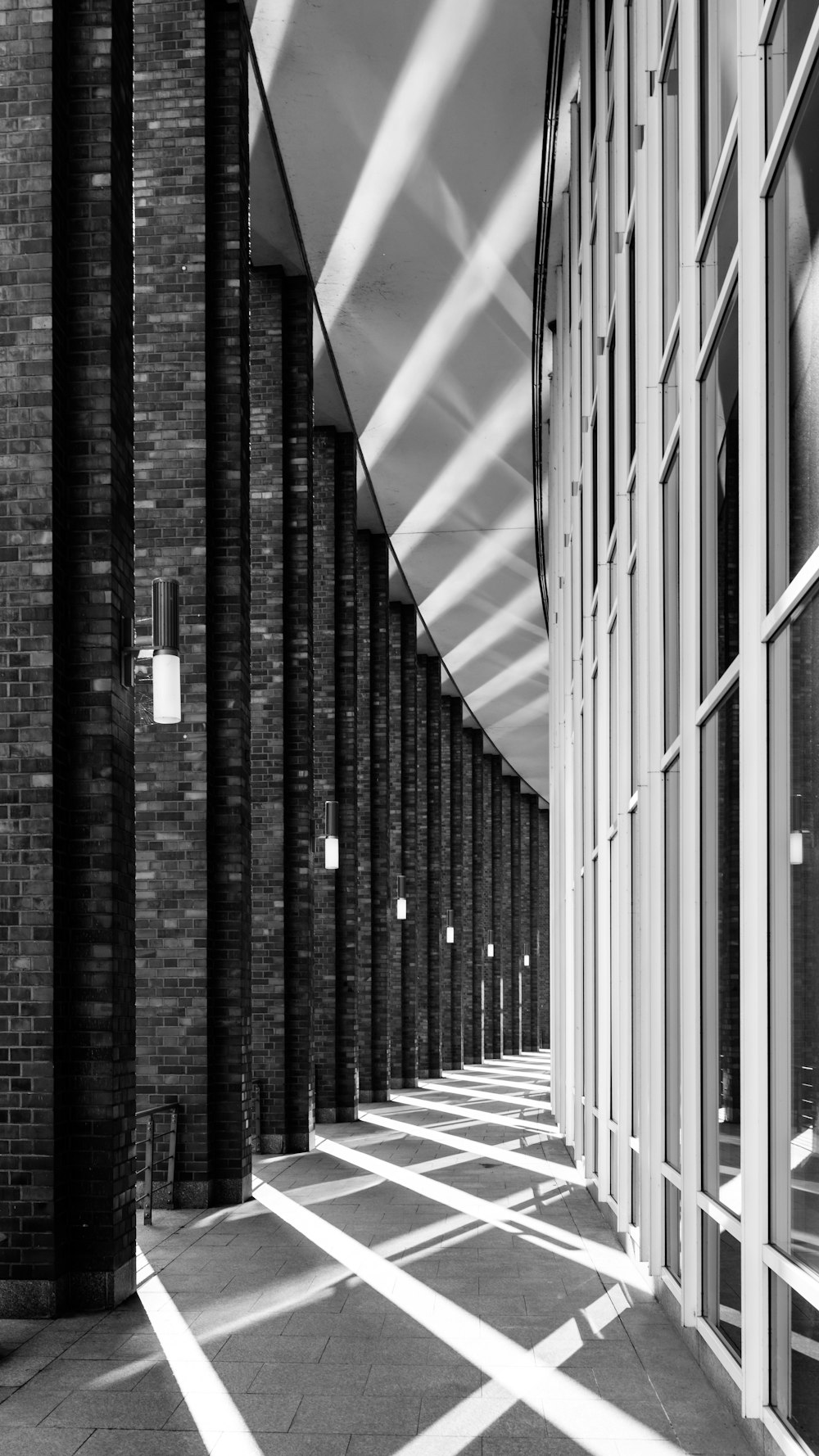 a black and white photo of a long hallway