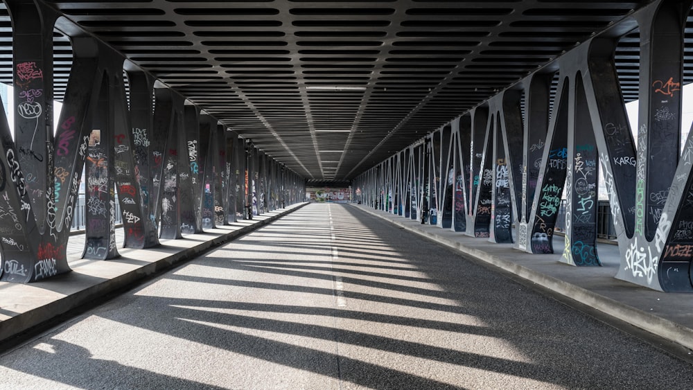 a long walkway with lots of graffiti on it