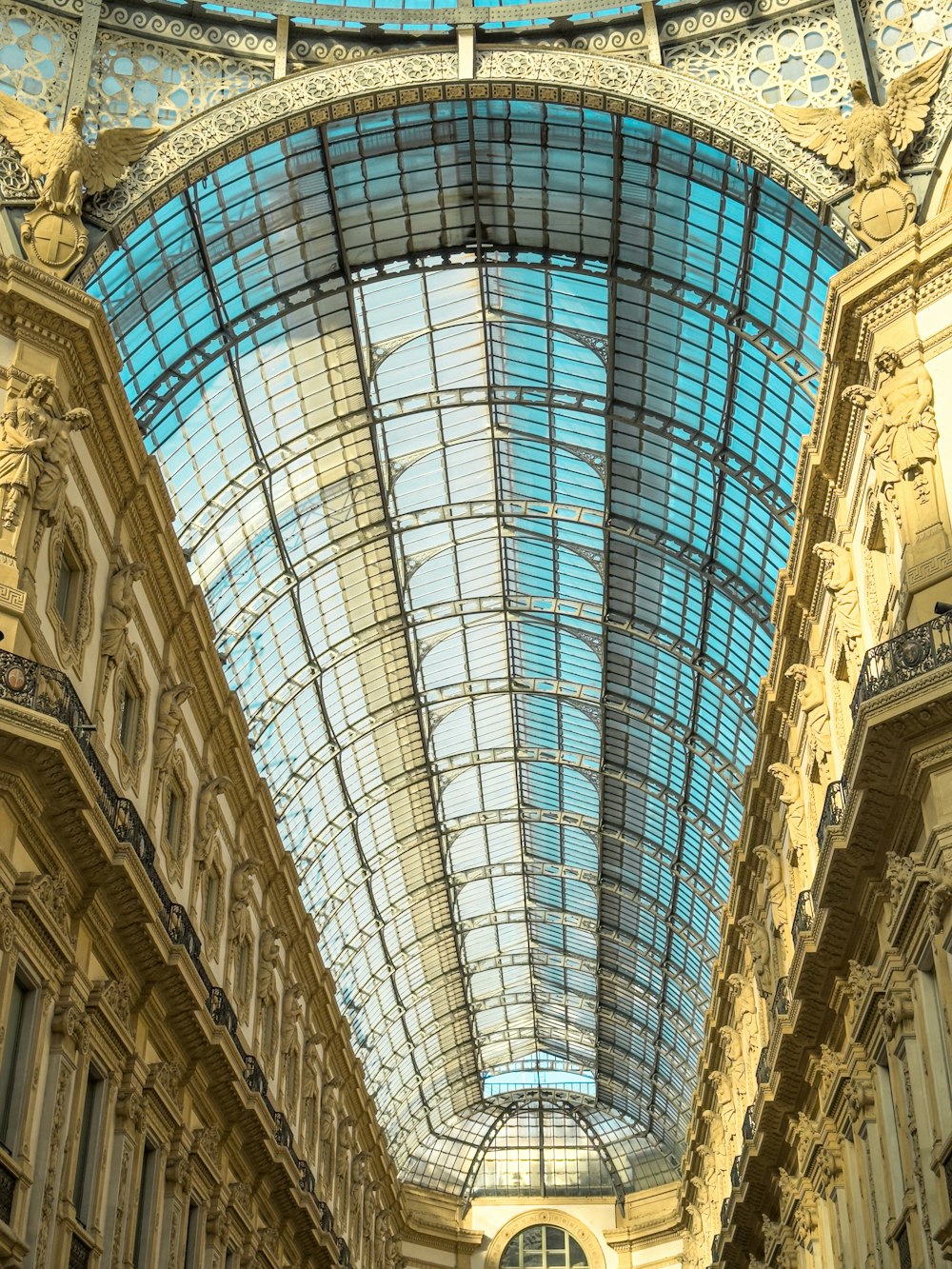 a building with a glass roof and a clock on it