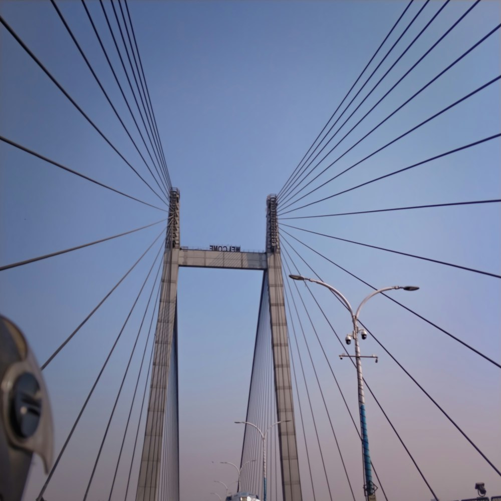 a view of a very tall bridge from a car