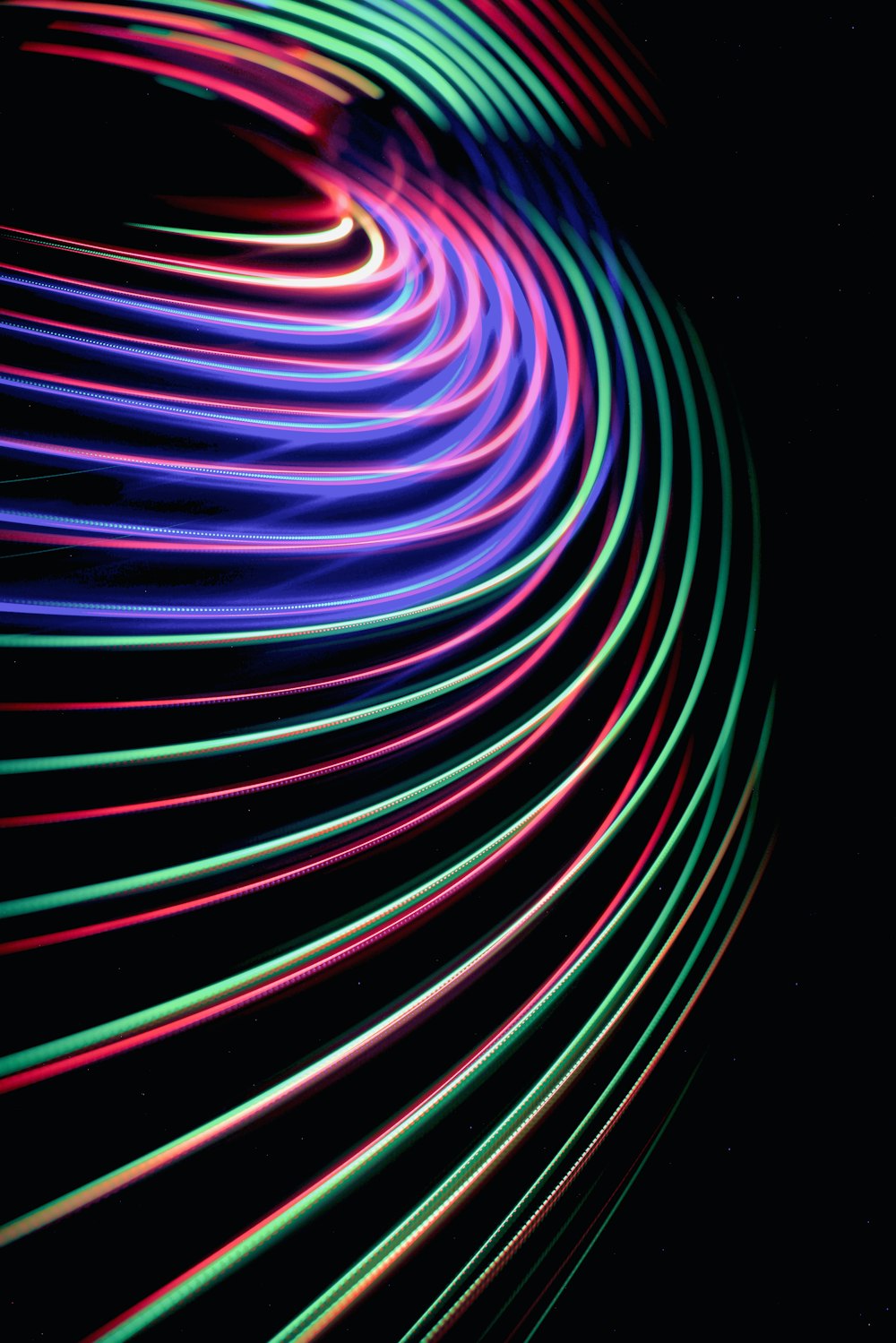 a black background with multicolored lines in the dark