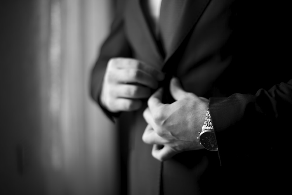 a close up of a person wearing a suit and tie