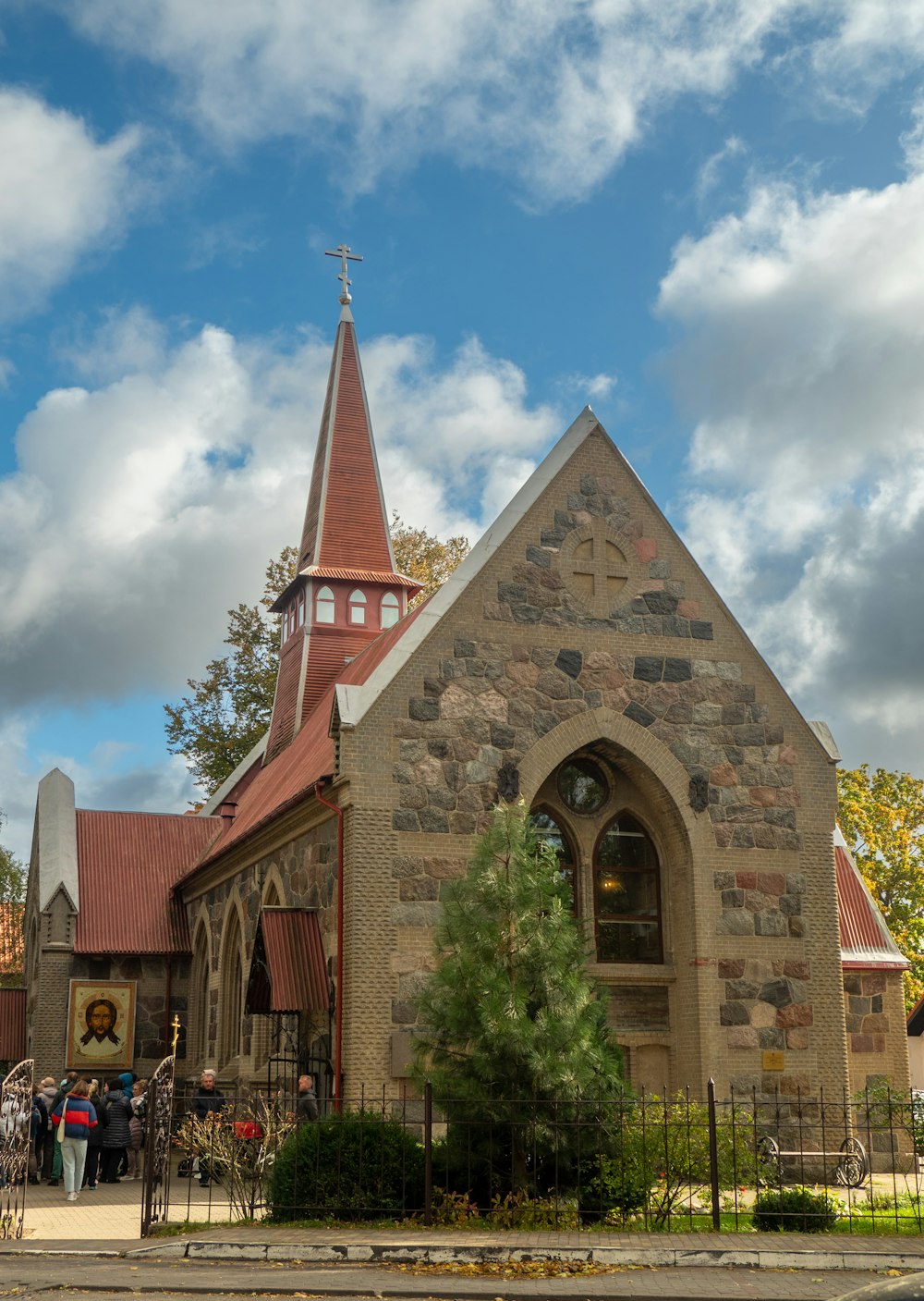 a church with a tall steeple and a clock tower