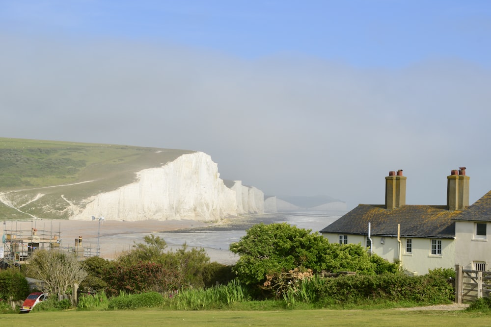 a view of a beach with a white cliff in the background