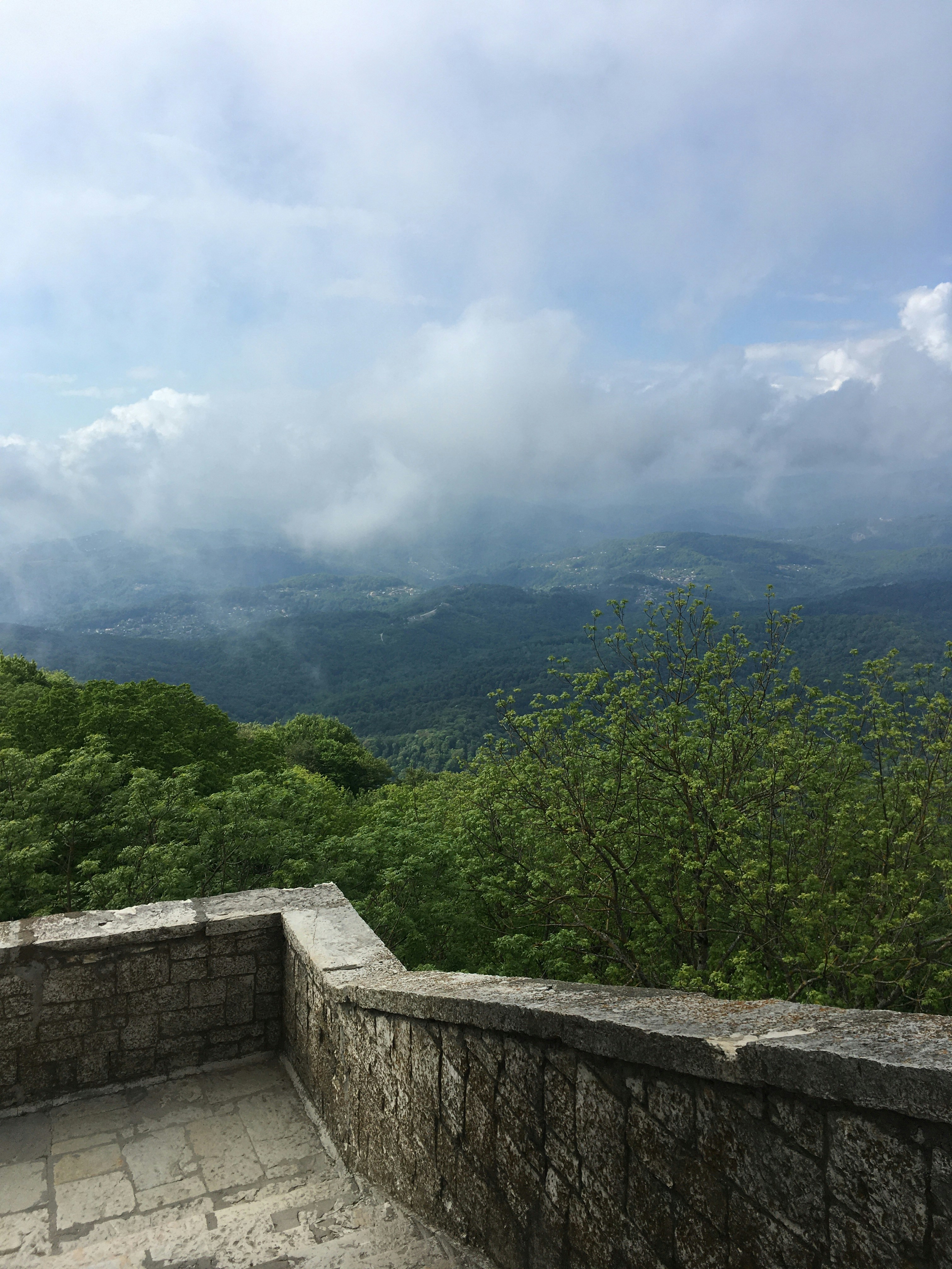 a stone wall with a view of the mountains
