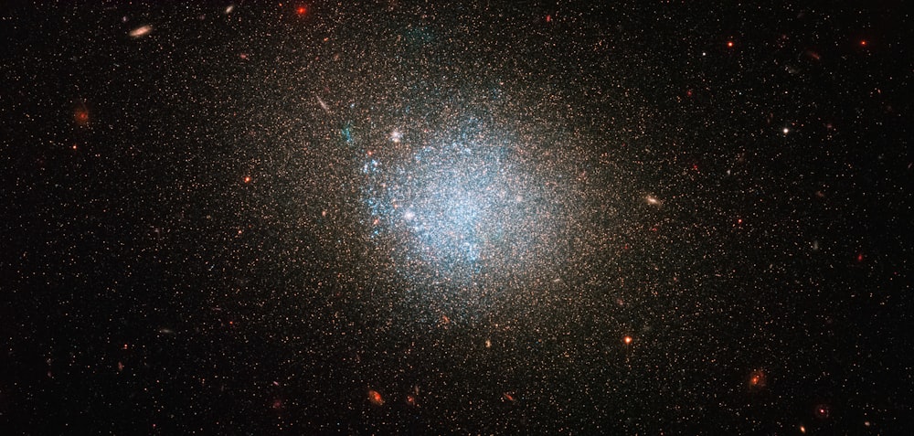 a bright blue object in the middle of a dark sky