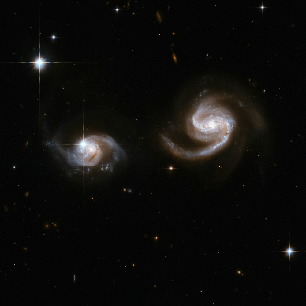 two spirally shaped objects in the dark sky