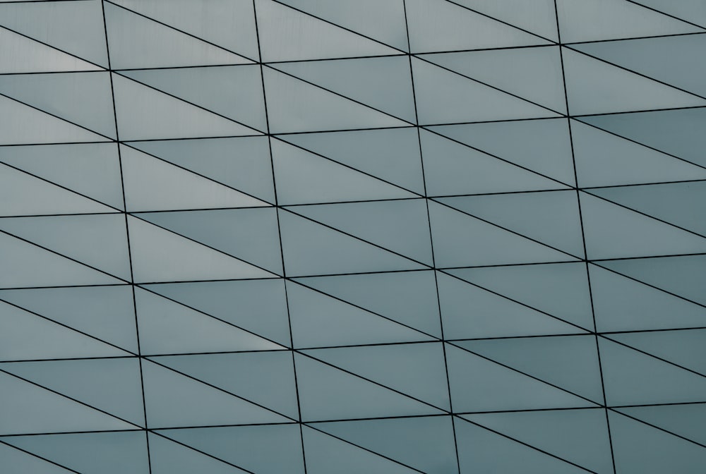 a plane flying in the air near a building