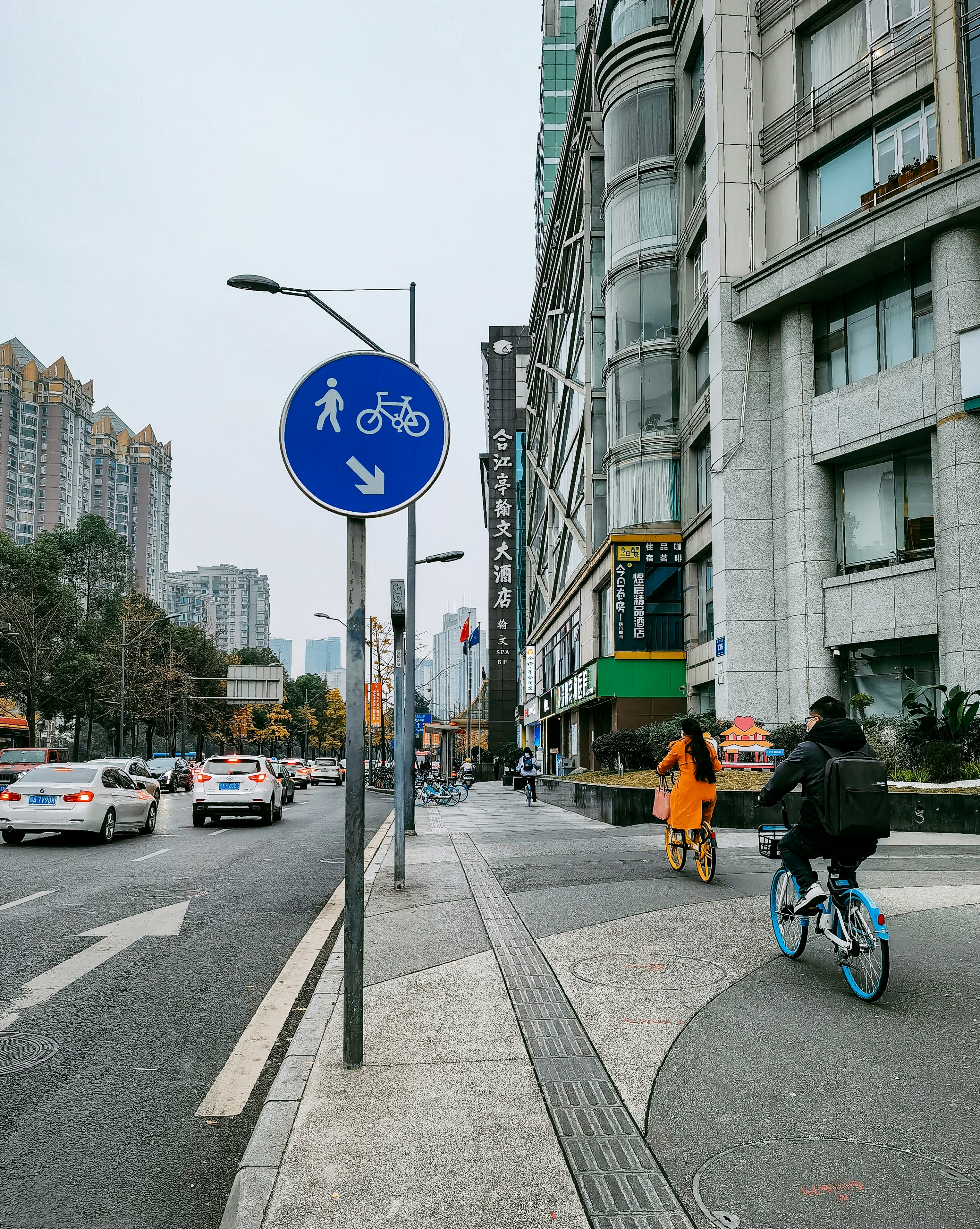 a person riding a bike on a city street