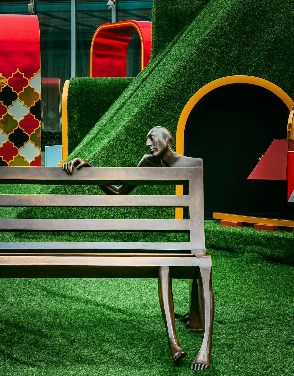 a wooden bench sitting on top of a lush green field