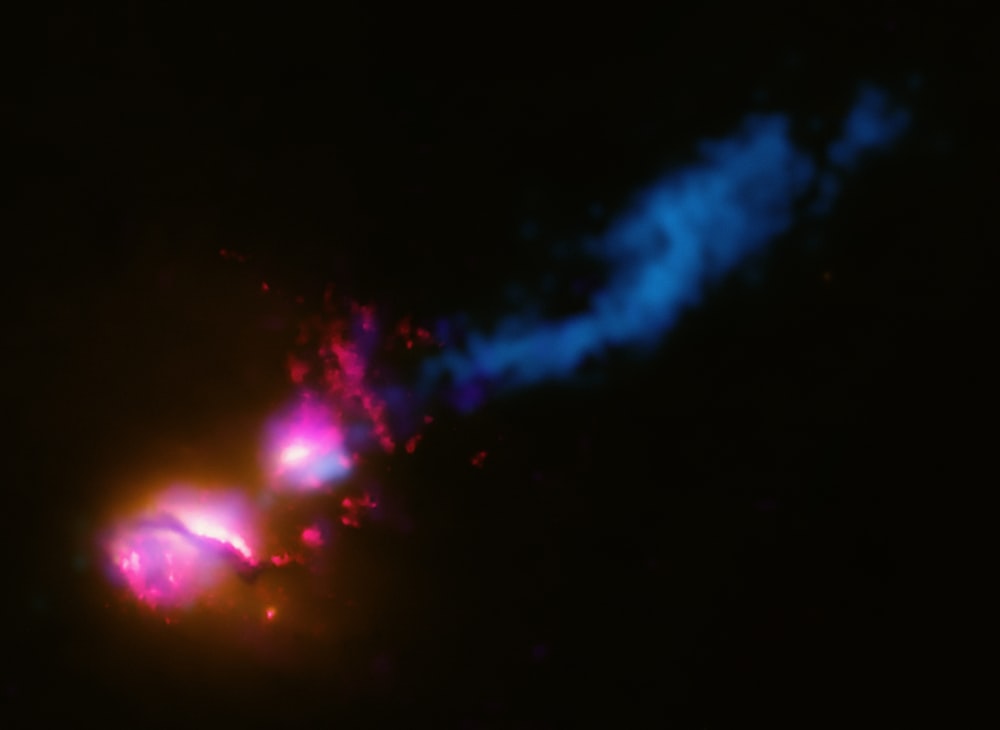 a blurry image of a blue and pink object in the dark
