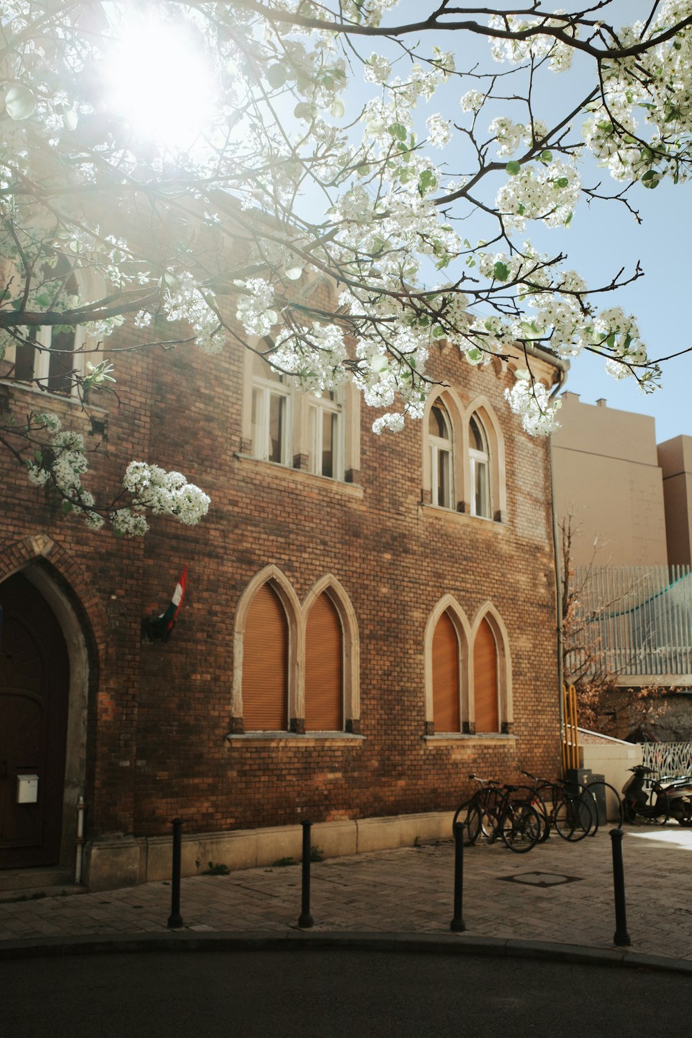 a brick building with a tree in front of it