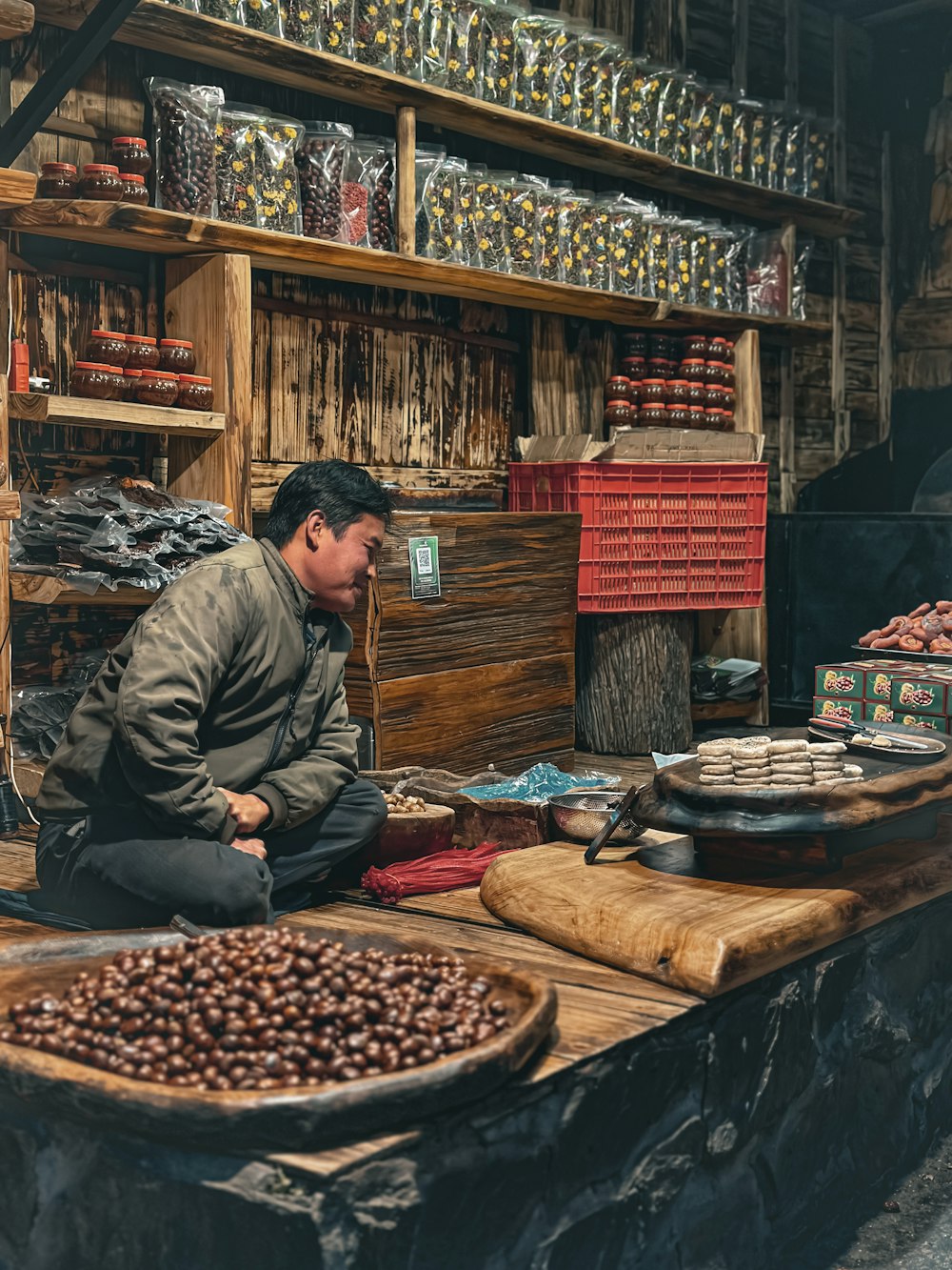 a man sitting on a table in front of a store