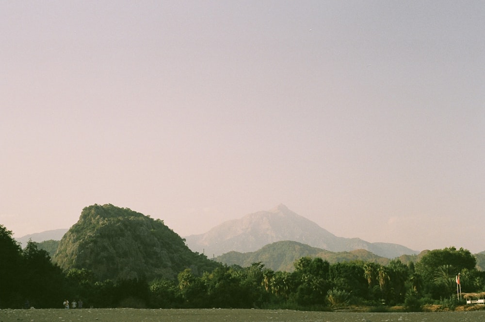 a large body of water with mountains in the background