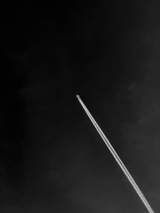 an airplane is flying high in the sky