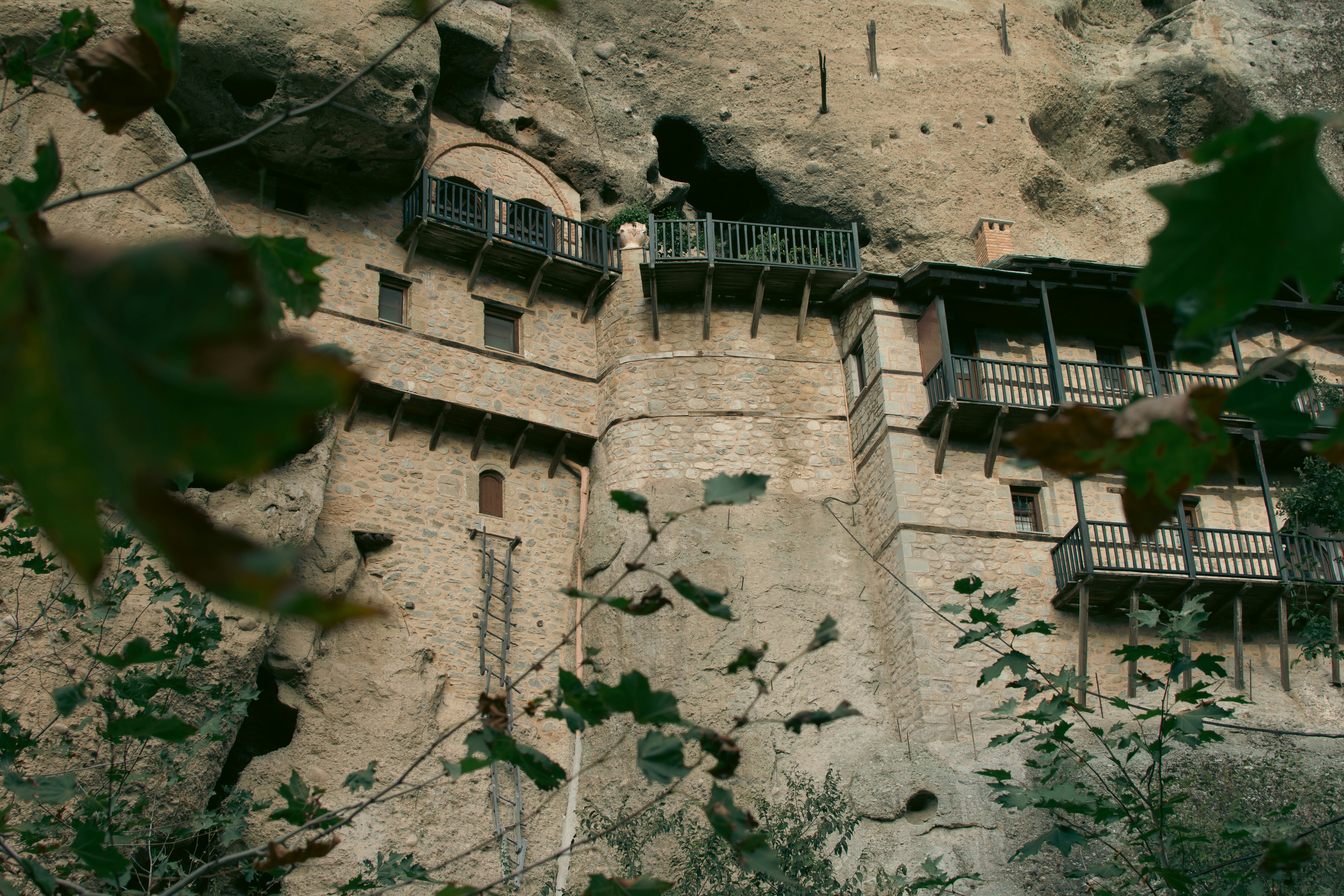a very tall building sitting on the side of a cliff