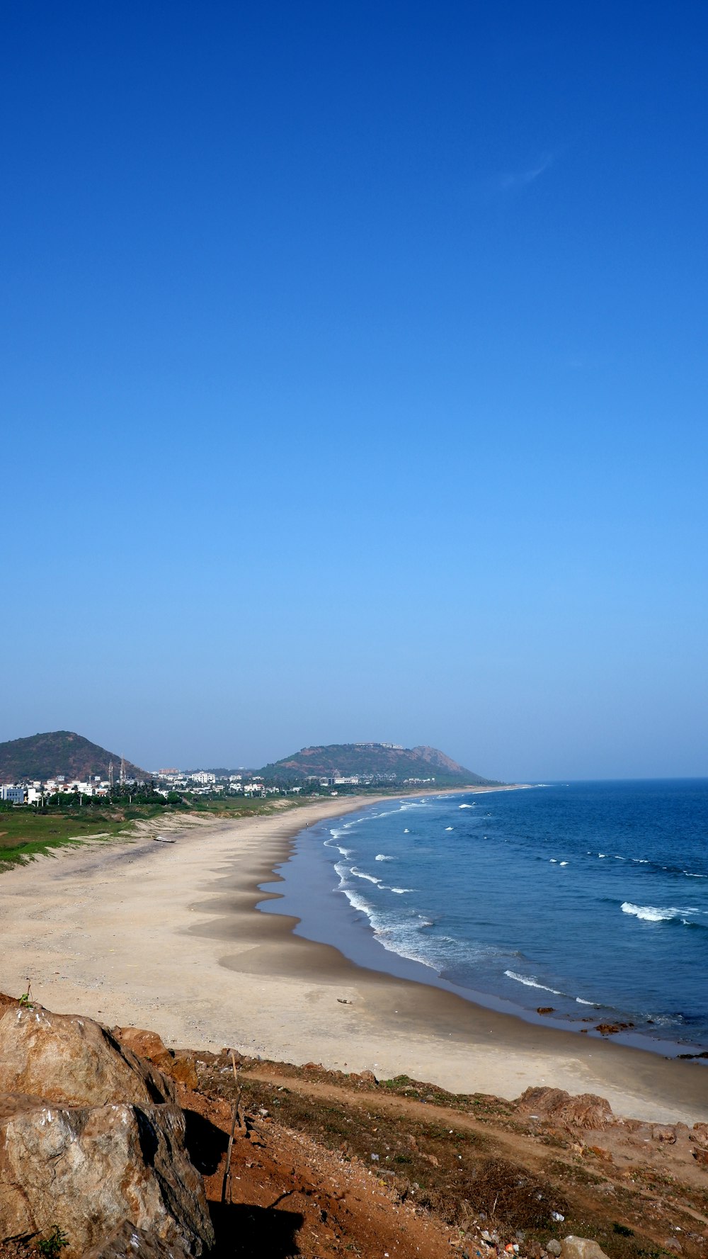 a view of a beach from the top of a hill