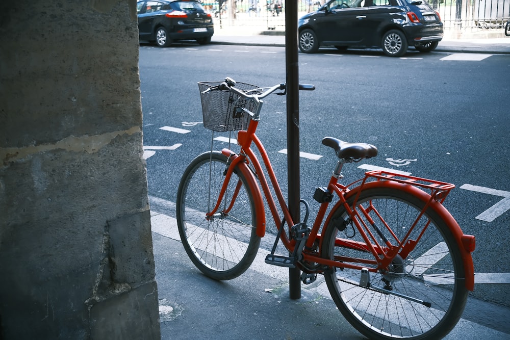 a red bicycle parked on the side of a street