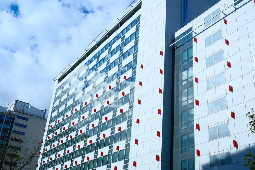 a tall building with red and white squares on it