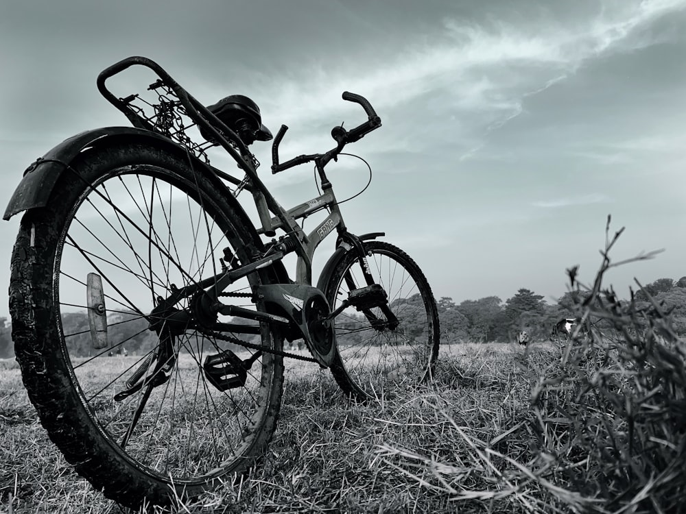 a bike parked in the middle of a field