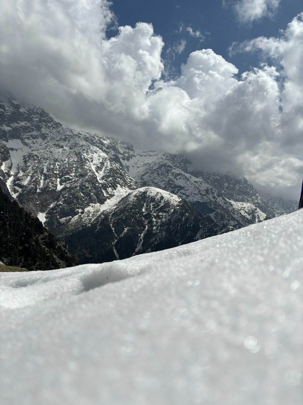 a man riding skis down the side of a snow covered slope