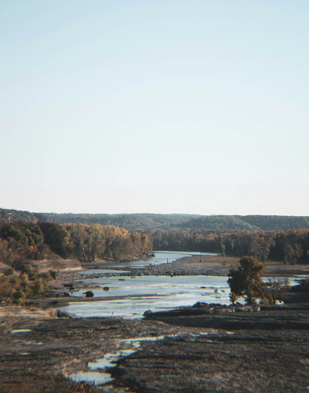 a body of water surrounded by trees and land