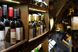 a bunch of bottles of wine on a shelf