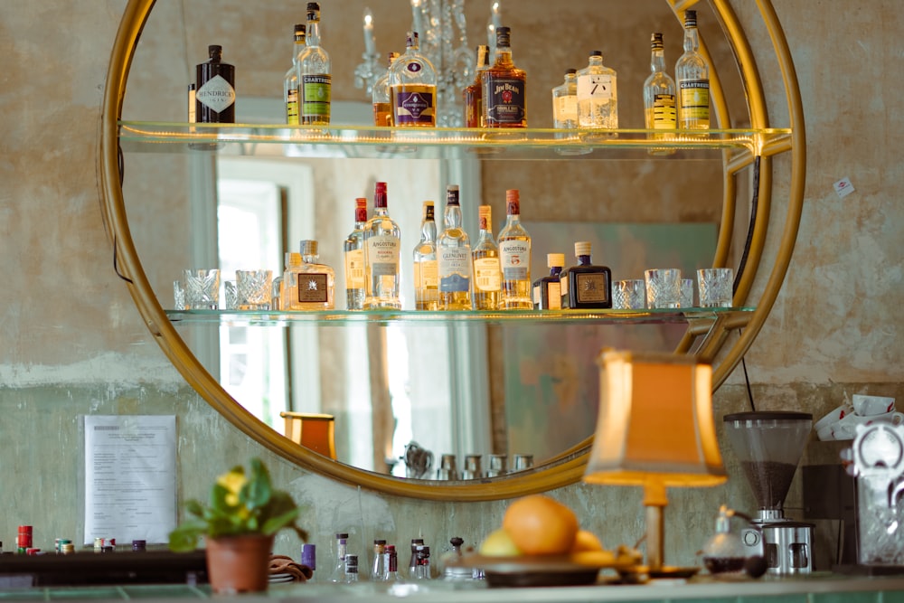 a bar with liquor bottles and glasses on a shelf