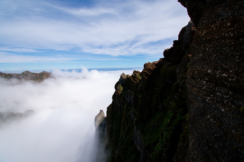 a man standing on top of a tall cliff