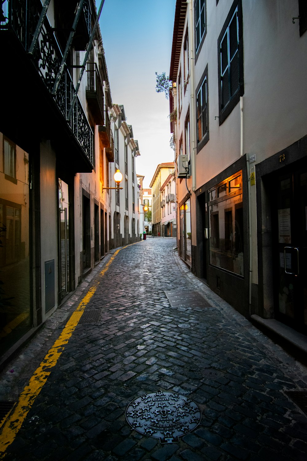 a cobblestone street with a yellow line painted on the side