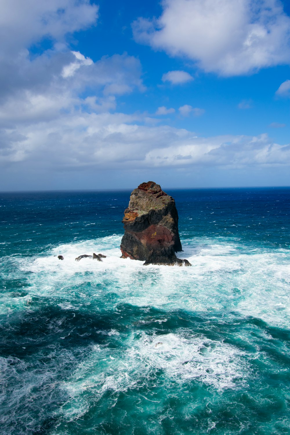 a rocky outcropping in the middle of the ocean