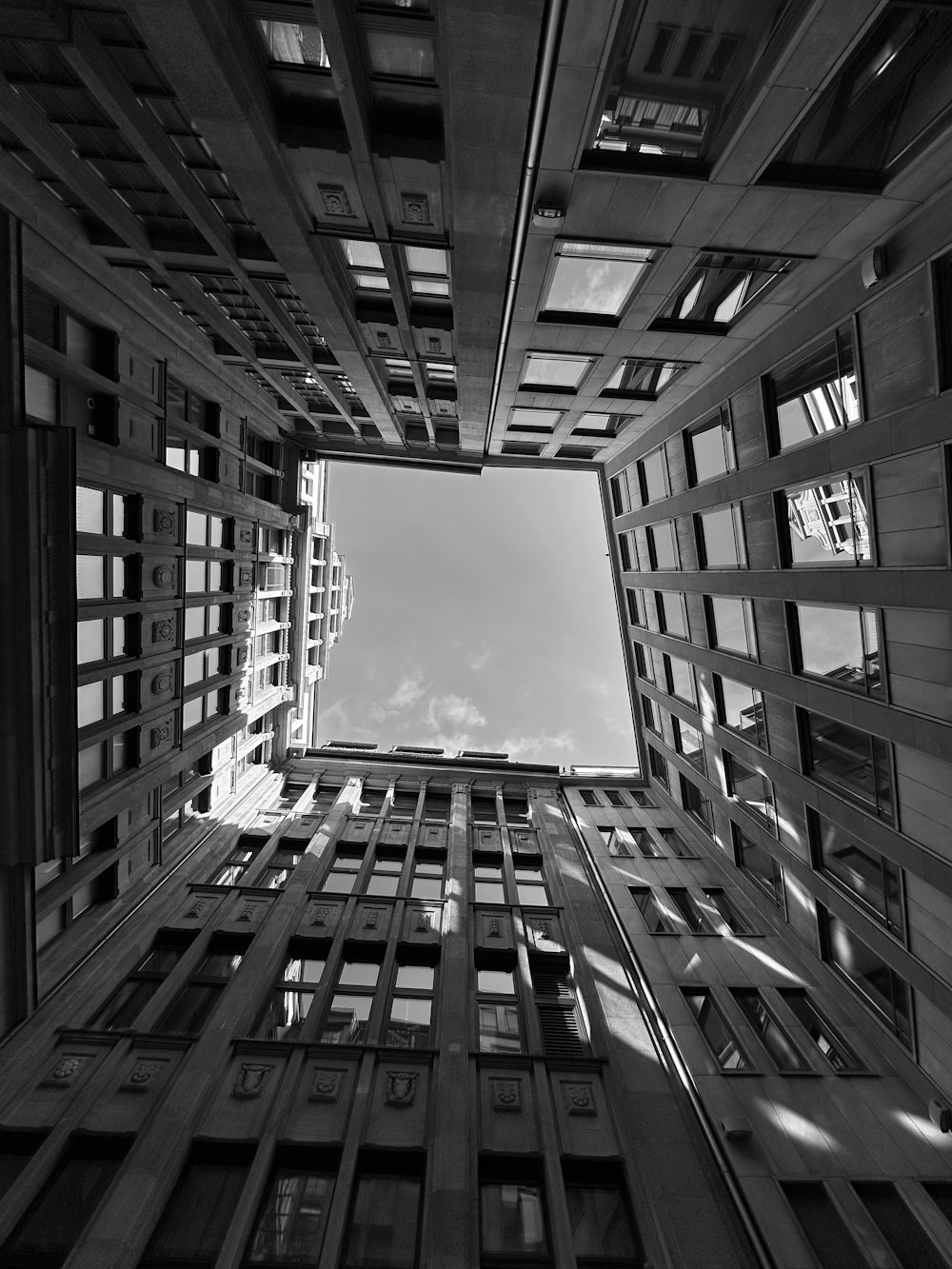 a black and white photo of tall buildings